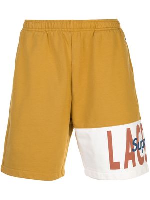 Supreme Lacoste logo panel track shorts - Gold