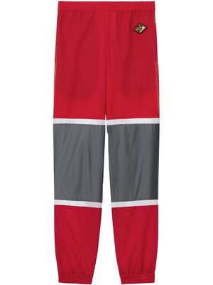 Burberry Logo Graphic Striped Nylon Trackpants - Red