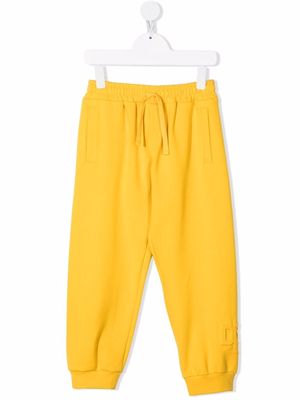 Dolce & Gabbana Kids embossed logo track pants - Yellow