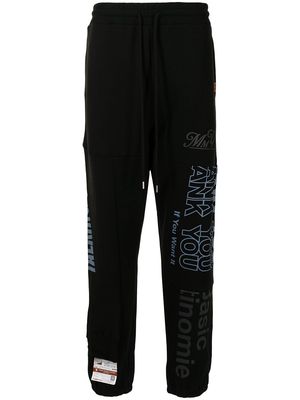 Maison Mihara Yasuhiro slogan-print track pants - Black
