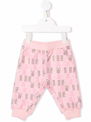 Moschino Kids all-over logo-print trousers - Pink