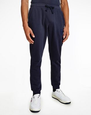 Tommy Jeans tonal flag logo cuffed sweatpants in navy