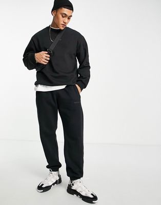 adidas Originals Trefoil Linear sweatpants in black with leg patch