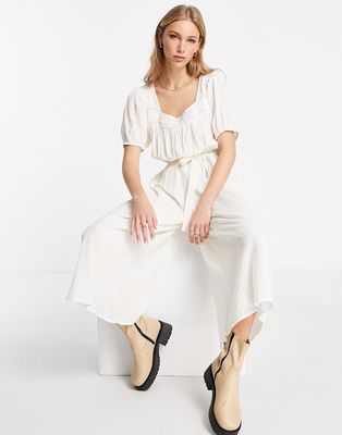 ASOS DESIGN off-shoulder embroidered jumpsuit with tie waist in off-white