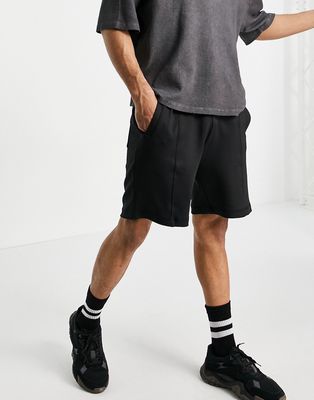 Bershka oversized jersey shorts in black