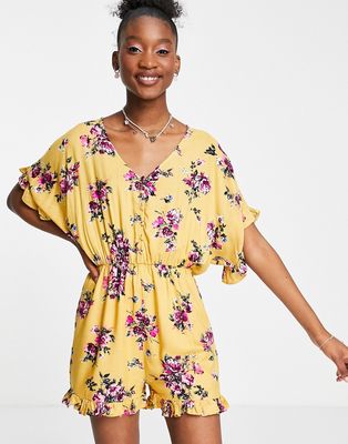 En Crème romper in yellow floral with frill hem