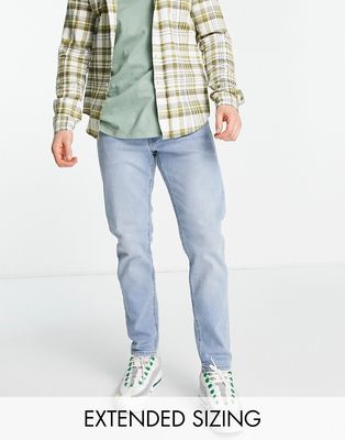 ASOS DESIGN tapered jeans in light wash blue-Blues
