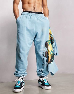 ASOS Dark Future relaxed sweatpants with dice graphic print and logo in aqua blue - part of a set