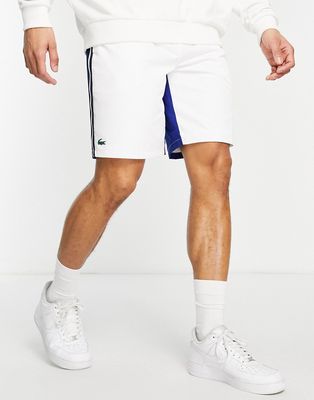 Lacoste Sport shorts with blue paneling in white