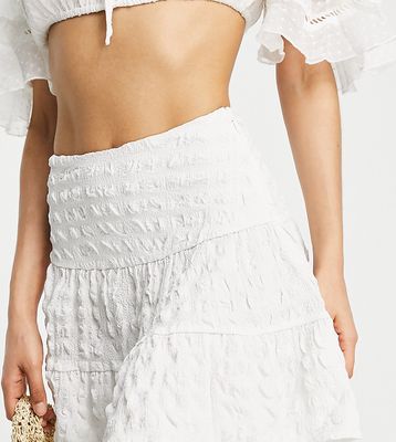 ASOS DESIGN Petite tiered mini skirt in poly plaid in white