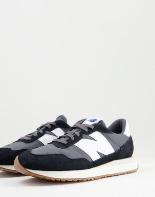 New Balance 237 sneakers in black with gum sole