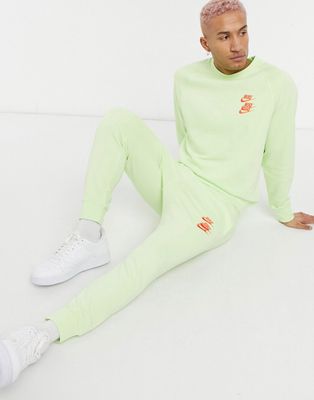 Nike World Tour Pack graphic cuffed sweatpants in lime-Green