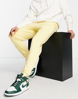 Siksilk sweatpants in washed yellow with logo badge