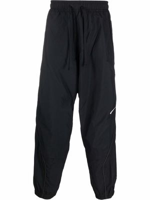 Nike swoosh-logo print track pants - Black