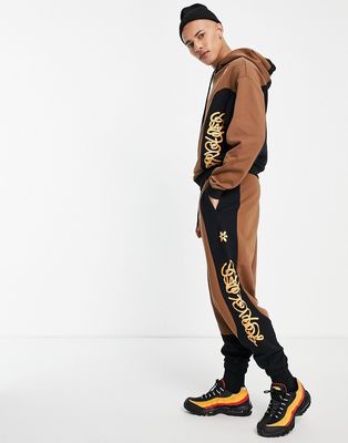 Crooked Tongues sweatpants with quilted panels in brown