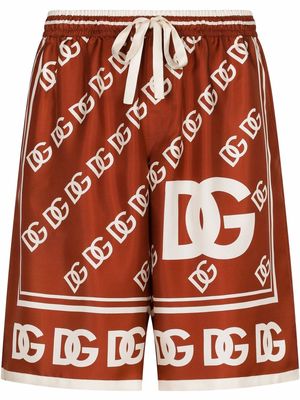 Dolce & Gabbana all-over logo print silk shorts - Red