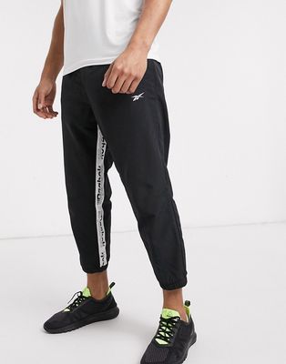 Reebok Training woven sweatpants with logo taping in black