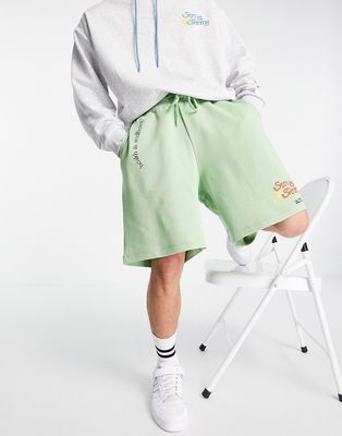 ASOS Actual coordinating relaxed shorts with multi logo and graphic prints in green