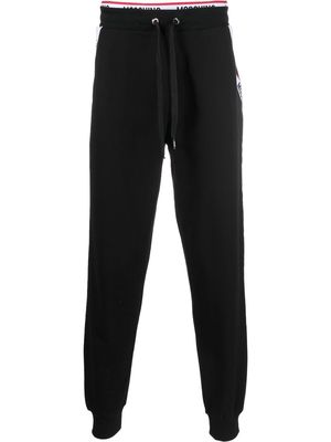 Moschino logo-waistband trousers - Black