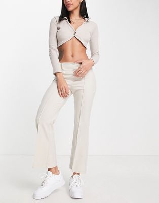 Pull & Bear mid rise flare pants with pocket detail in beige-Neutral