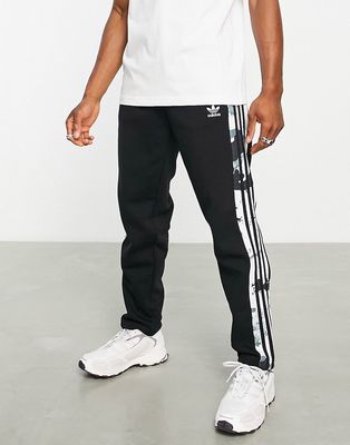 adidas Originals Graphics camo three stripe sweatpants in focus black