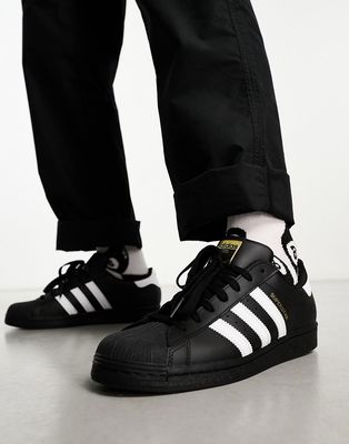 adidas Originals Superstar sneakers in black and white