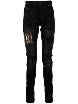 AMIRI appliqué-logo distressed-effect slim-fit jeans - Black