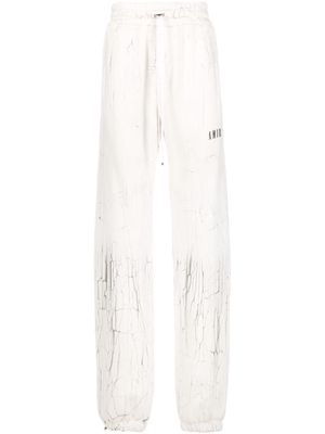AMIRI cracked-print track pants - White