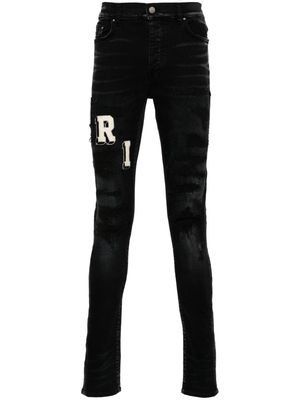 AMIRI logo-appliqué skinny jeans - Black