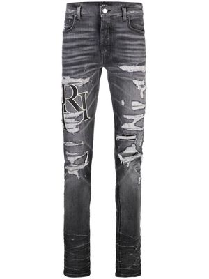 AMIRI logo-print ripped skinny jeans - Grey