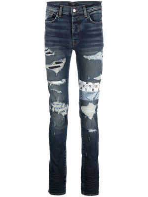 AMIRI patchwork distressed slim jeans - Blue