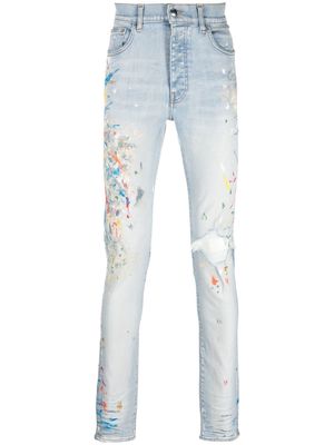 AMIRI spray-paint effect distressed skinny jeans - Blue