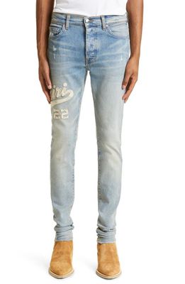AMIRI Varsity Logo Distressed Stretch Denim Skinny Jeans in Clay Indigo