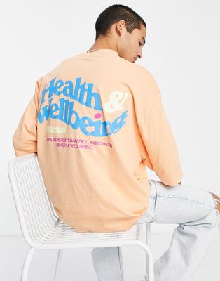 ASOS Actual oversized t-shirt with health & wellbeing back print logo in orange