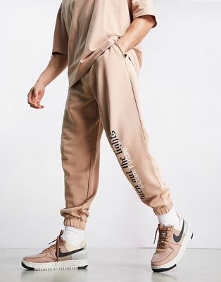 ASOS Dark Future relaxed sweatpants with slogan and logo print in taupe - part of a set-Neutral