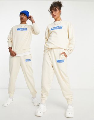 ASOS Daysocial unisex relaxed sweatpants with blue badge logo print in ecru - part of a set-White
