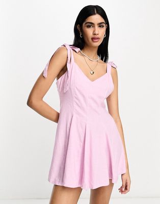ASOS DESIGN linen tie cross strap swing mini sundress with flares in pink