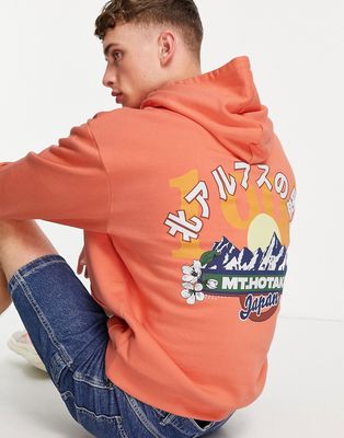 ASOS DESIGN oversized hoodie in orange with mountain back print