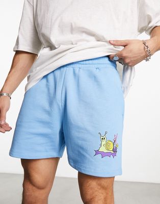 ASOS DESIGN oversized shorts in blue with cartoon print