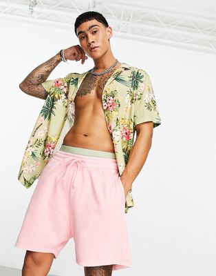 ASOS DESIGN oversized shorts in pink overdye wash