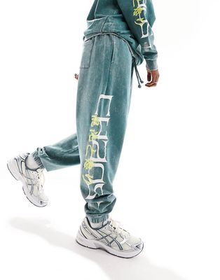 ASOS DESIGN oversized sweatpants in dark green acid wash with side text print & embroidery - part of a set