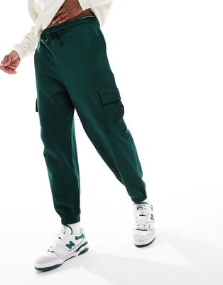 ASOS DESIGN oversized sweatpants with cargo pockets in dark green
