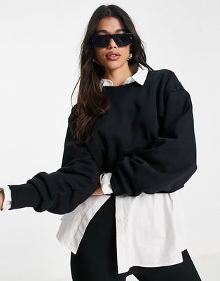 ASOS DESIGN oversized sweatshirt with raw hem in black
