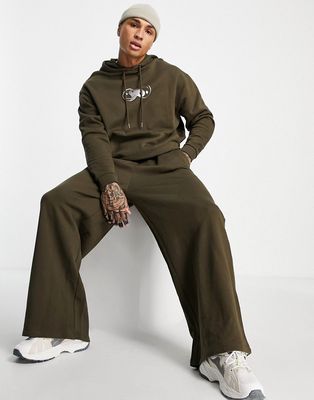 ASOS DESIGN oversized tracksuit in brown with metallic chest print