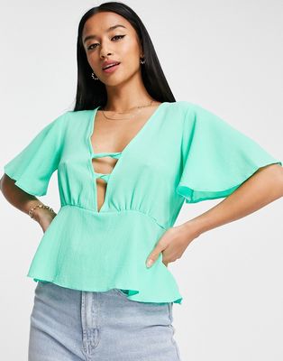 ASOS DESIGN Petite tea blouse with peplum hem and angel sleeves with twist front detail in bright green