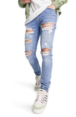 ASOS DESIGN Ripped Skinny Jeans in Mid Blue
