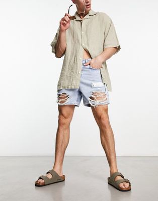 ASOS DESIGN shorter length denim shorts in mid wash blue with rips