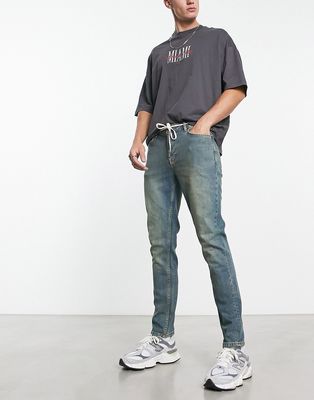 ASOS DESIGN skinny jeans in Y2k heavy tinted mid wash blue