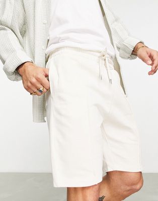 ASOS DESIGN smart tapered jersey shorts with pin tuck in beige-Neutral