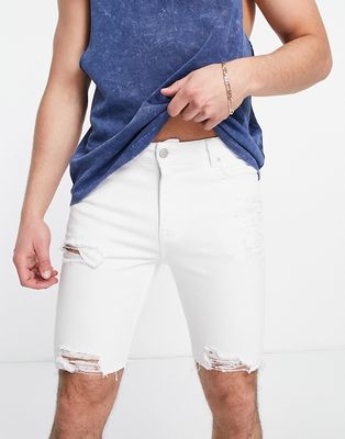 ASOS DESIGN spray on denim shorts with power stretch in white with heavy rips and raw hem